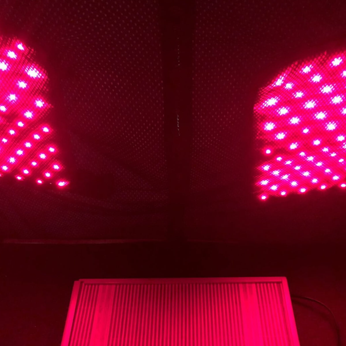 Inside the Thera360 Plus sauna, showing illuminated panels and the wooden foot area.